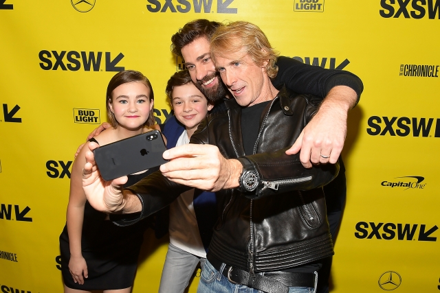 Michael Bay taking a selfie with John Krasinski, Noah Jupe, and Millicent Simmonds.